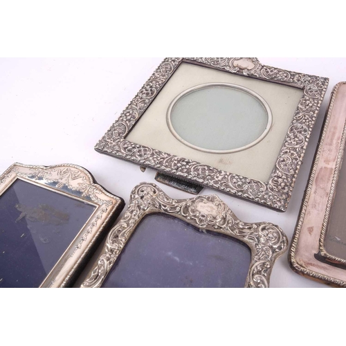 495 - An oval silver easel photograph frame, Birmingham 1922, by Baldwin & Marriott, with tied ribbon cres... 