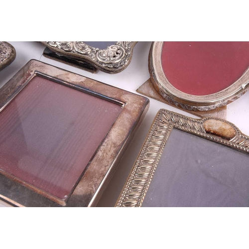 495 - An oval silver easel photograph frame, Birmingham 1922, by Baldwin & Marriott, with tied ribbon cres... 