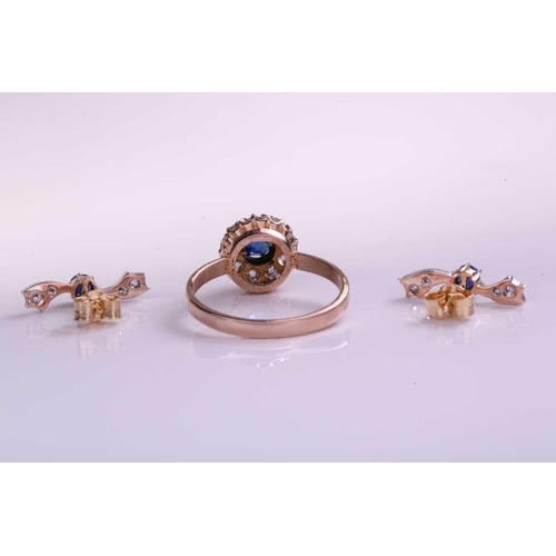 5 - A Sapphire and Diamond cluster ring and earring set, the ring is formed from a central claw set sapp... 