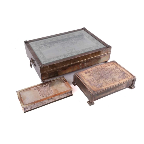 500 - Three silver plated cigar boxes comprising a humidor with a hinged cover inset with a 20th century p... 