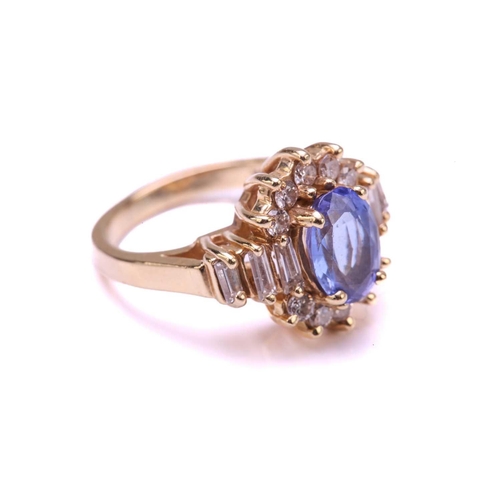 52 - A tanzanite and diamond cluster ring and a pair of matching earrings; the ring comprises an oval tan... 