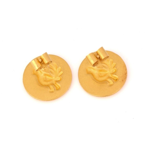 57 - A pair of stud earrings with bird motifs, each comprises a round plaque with a twisted rope edge, re... 