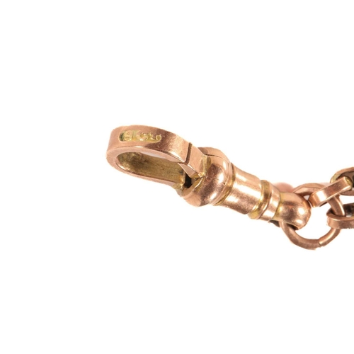 62 - A late Victorian guard chain in 9ct gold, comprising flat cable links connecting to a swivel clasp, ... 