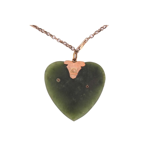 64 - A Nephrite heart shape pendant measuring 39x39mm on yellow metal stamped 9ct on base metal chain. To... 