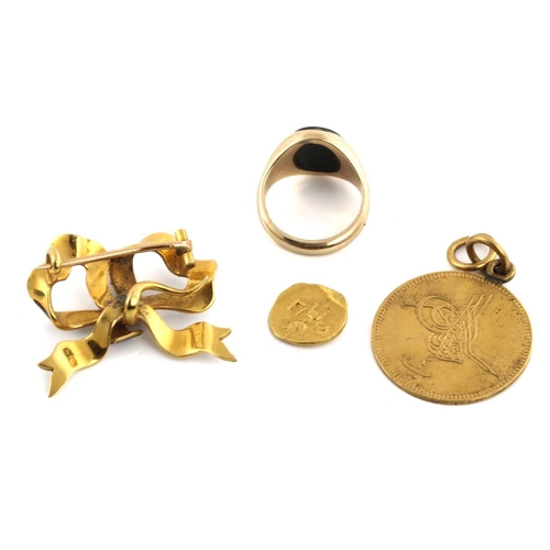 66 - A 9ct gold signet ring, an enamel brooch, a pendant and a coin; A signet ring consists of an oval on... 