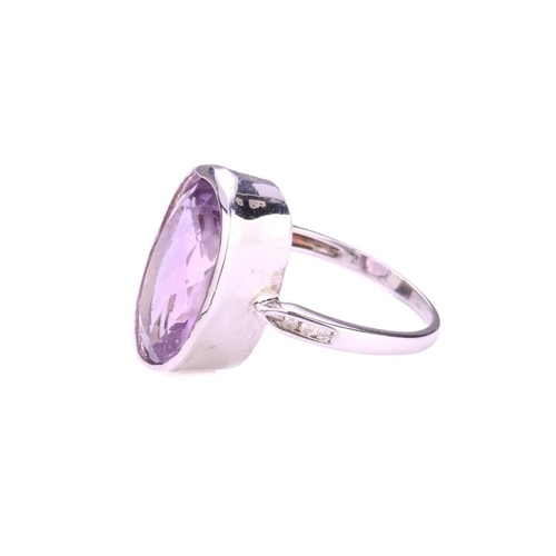 73 - An amethyst dress ring in 18ct white gold, comprising an oval-cut amethyst in tube collet, approxima... 