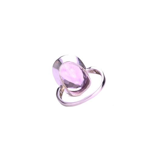 73 - An amethyst dress ring in 18ct white gold, comprising an oval-cut amethyst in tube collet, approxima... 