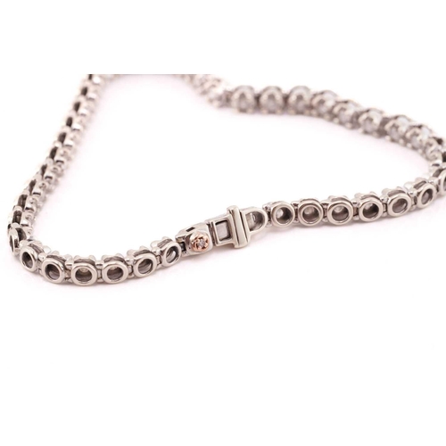 89 - A diamond line bracelet in 9ct white gold, comprising a single row of brilliant-cut diamonds, approx... 