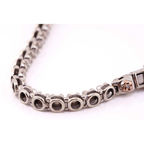 89 - A diamond line bracelet in 9ct white gold, comprising a single row of brilliant-cut diamonds, approx... 