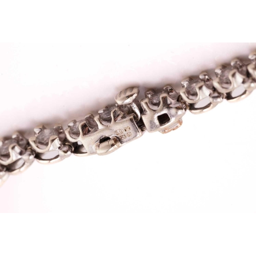 89 - A diamond line bracelet in 9ct white gold, comprising a single row of brilliant-cut diamonds, approx... 