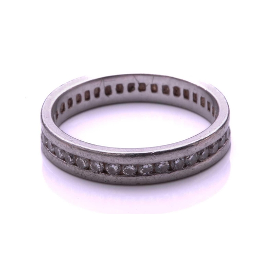 9 - A full hoop diamond eternity ring, the round brilliant cut diamonds channel mounted within a platinu... 