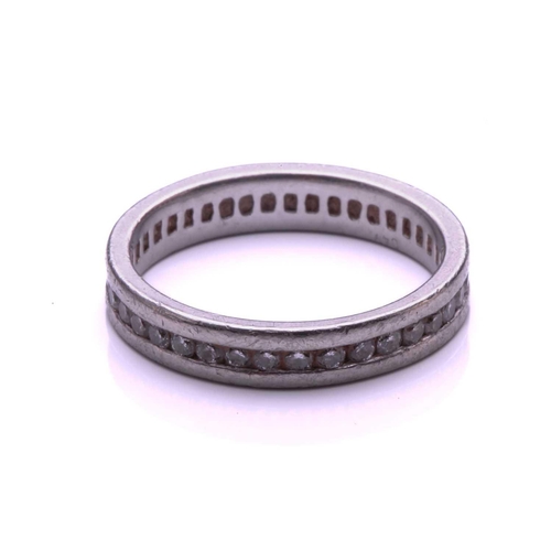 9 - A full hoop diamond eternity ring, the round brilliant cut diamonds channel mounted within a platinu... 