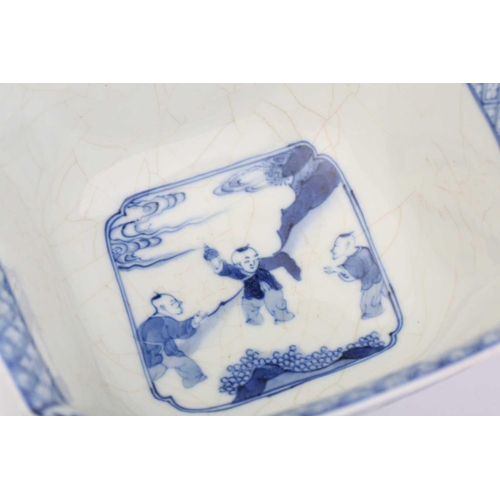 197 - A Chinese blue and white porcelain canted square section bowl the interior painted with boys a play ... 