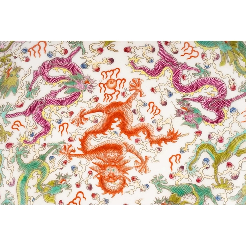 201 - A Chinese porcelain 'Nine Dragon' dish, painted with a variety of writhing dragons amongst fiery clo... 