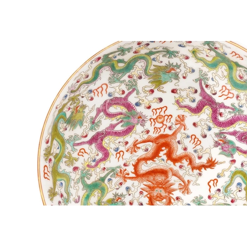 201 - A Chinese porcelain 'Nine Dragon' dish, painted with a variety of writhing dragons amongst fiery clo... 