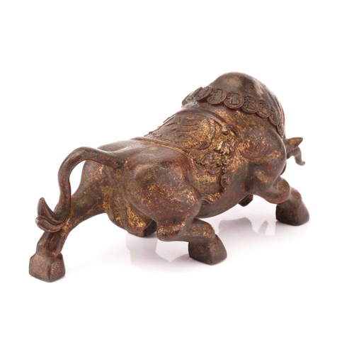 207 - A Chinese patinated and gilt bronze figure of a charging bull with cash bridle and saddle cloth. 27 ... 