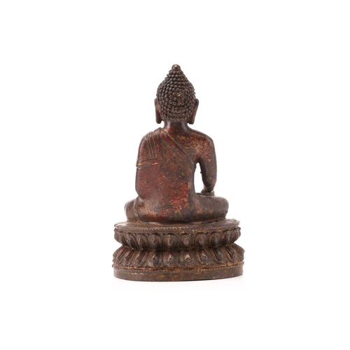 212 - A patinated and gilt bronze figure of a Tibetan-style Buddha seated in dhyansana mudra upon a double... 