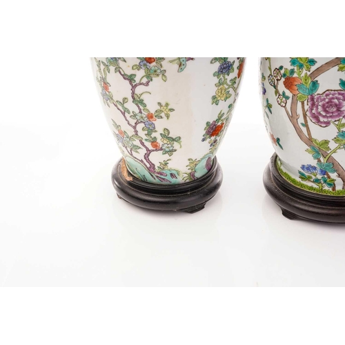 213 - A pair of Chinese Famile rose porcelain baluster vase form table lamps, 20th century, painted with c... 