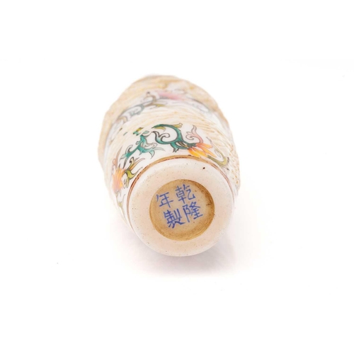 217 - A Chinese milk glass snuff bottle, moulded in relief with a gilt dragon above a Fenghuang, amongst p... 