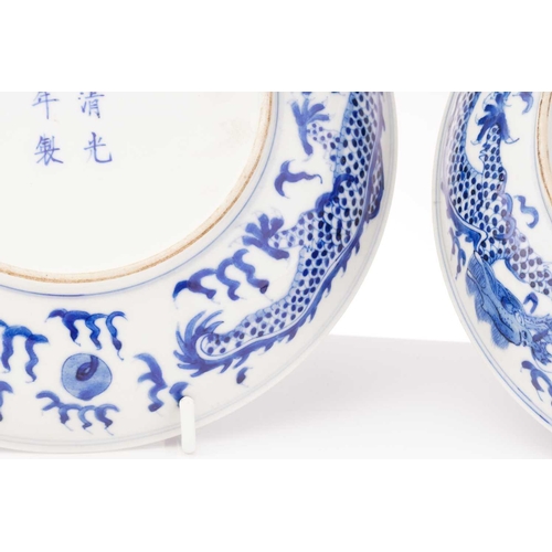 234 - A pair of Chinese porcelain blue & white 'Dragon' dishes, painted with a writhing dragon chasing a p... 