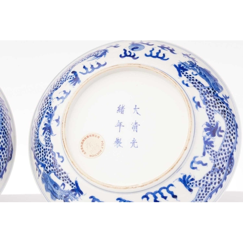 234 - A pair of Chinese porcelain blue & white 'Dragon' dishes, painted with a writhing dragon chasing a p... 