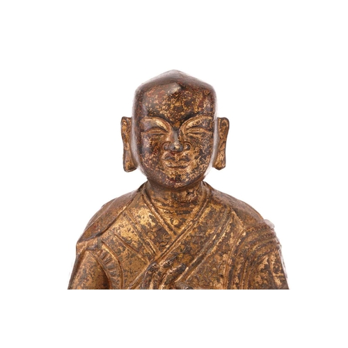 240 - A gilt-bronze figure of the Buddha seated in Vitaka mudra on a simple rectangular plinth. 17 cm wide... 