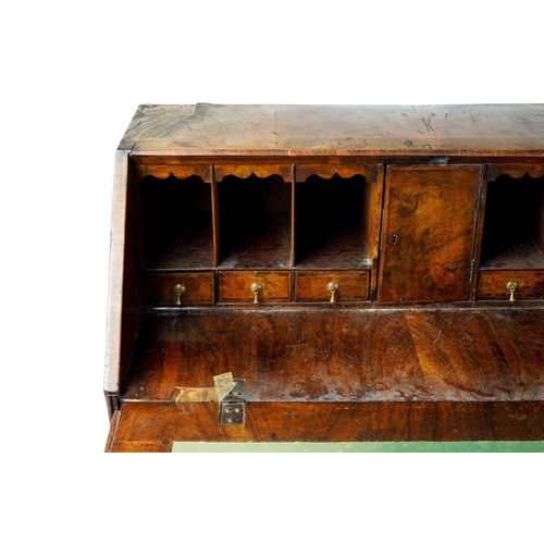 250 - A George II walnut fall front writing bureau with a simple fitted interior enclosed by a book-matche... 