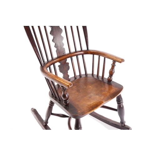 256 - An East Midlands hoop back Windsor rocking armchair, 19th century, with spindle and profile splat ba... 