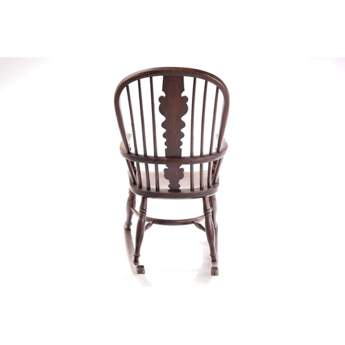 256 - An East Midlands hoop back Windsor rocking armchair, 19th century, with spindle and profile splat ba... 