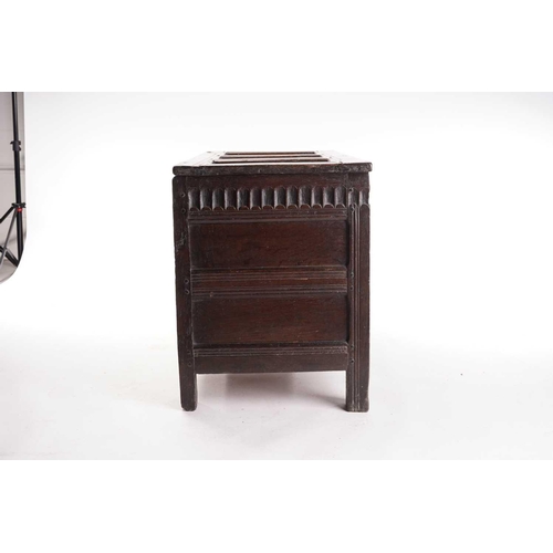 272 - An 18th century oak triple panelled coffer, the panelled hinged lid over a fluted frieze and panels ... 