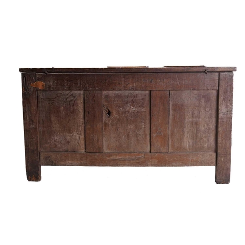 272 - An 18th century oak triple panelled coffer, the panelled hinged lid over a fluted frieze and panels ... 