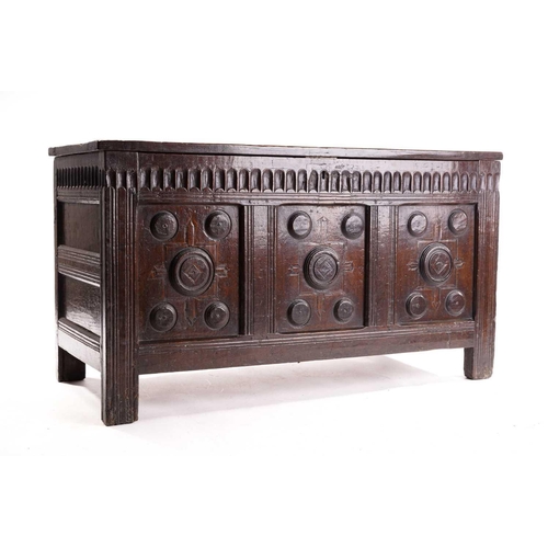 272 - An 18th century oak triple panelled coffer, the panelled hinged lid over a fluted frieze and panels ... 