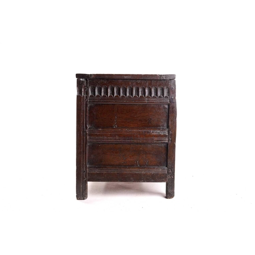 272 - An 18th century oak triple panelled coffer, the panelled hinged lid over a fluted frieze and panels ... 