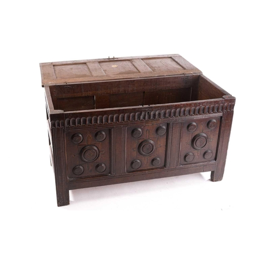 272 - An 18th century oak triple panelled coffer, the panelled hinged lid over a fluted frieze and panels ... 