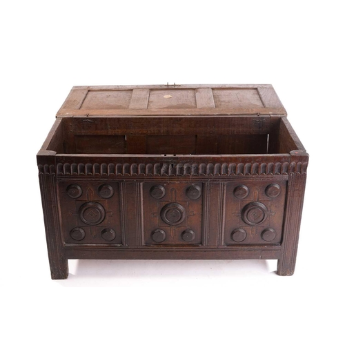 272 - An 18th century oak triple panelled coffer, the panelled hinged lid over a fluted frieze and panels ... 