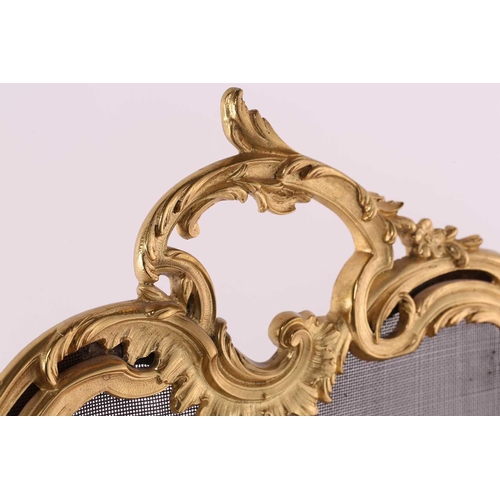 273 - A Louis XV style gilt metal firescreen, of shaped foliate scroll design to the centre depicting two ... 