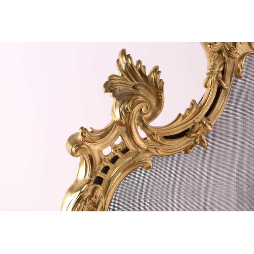 273 - A Louis XV style gilt metal firescreen, of shaped foliate scroll design to the centre depicting two ... 