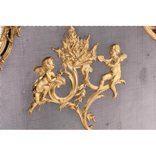 273 - A Louis XV style gilt metal firescreen, of shaped foliate scroll design to the centre depicting two ... 