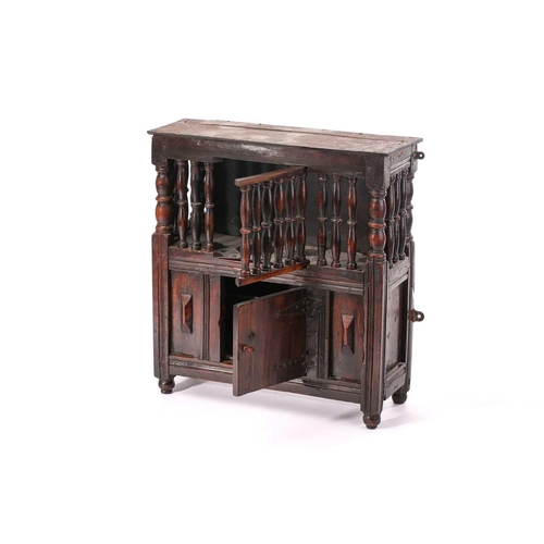 288 - A fruit wood dole cupboard, 17th century and later , the upper section enclosed by turned spindles a... 