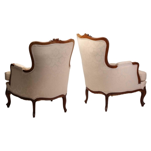 290 - A pair of Louis XV style walnut Bergere armchairs with rose carved cresting and moulded frame with i... 