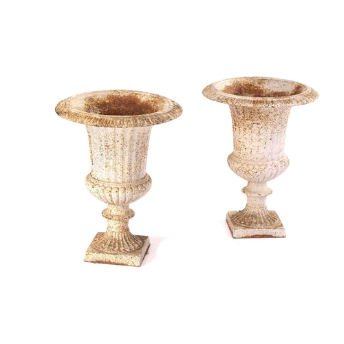 296 - A pair of Campagna form cast iron urns, 20th century, with egg and tongue border over volute columns... 