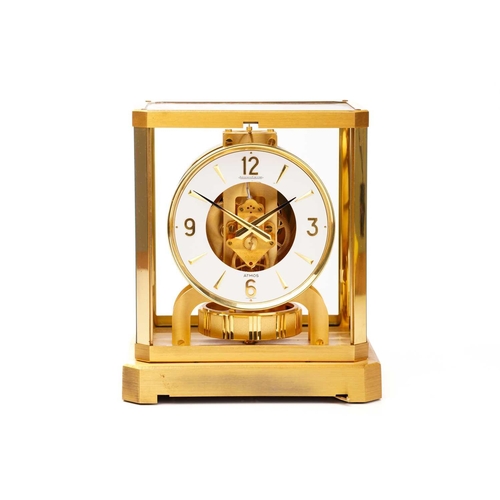 300 - A Jaeger LeCoultre brushed brass Atmos clock, no. 453672, with Arabic numerals at the quarter chapte... 