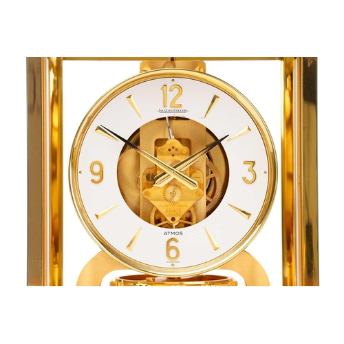 300 - A Jaeger LeCoultre brushed brass Atmos clock, no. 453672, with Arabic numerals at the quarter chapte... 