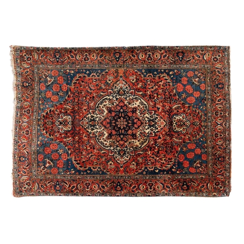 301 - A red ground Biidjar rug with medallion and corner design within broad borders. 202 cm x 146 cm, tog... 