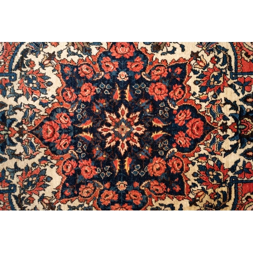 301 - A red ground Biidjar rug with medallion and corner design within broad borders. 202 cm x 146 cm, tog... 