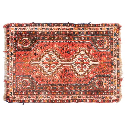 301 - A red ground Biidjar rug with medallion and corner design within broad borders. 202 cm x 146 cm, tog... 