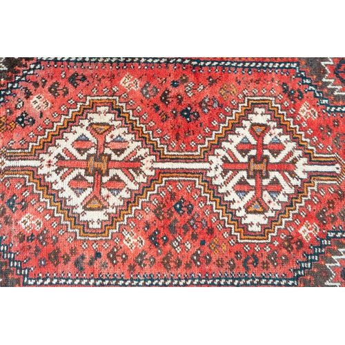 301 - A red ground Biidjar rug with medallion and corner design within broad borders. 202 cm x 146 cm, tog... 