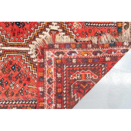 301 - A red ground Biidjar rug with medallion and corner design within broad borders. 202 cm x 146 cm, tog... 