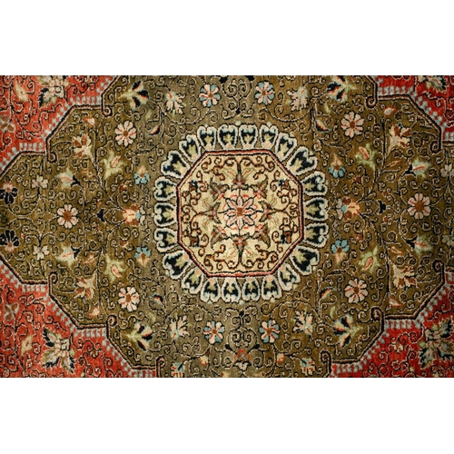 304 - An old brick red ground silk on silk Tabriz rug with central geometric lozenge with hanging lanterns... 