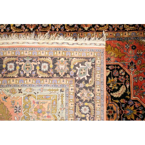 313 - An old brick red ground Heriz style silk on silk rug with central star lozenge with hanging lanterns... 